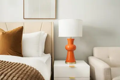 a lamp on a night stand next to a bed at 73-1104 New Studio UWS Doorman Gym in New York