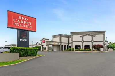 a red carrett inn and suites sign in front of a building at Red Carpet Inn & Suites in Philadelphia