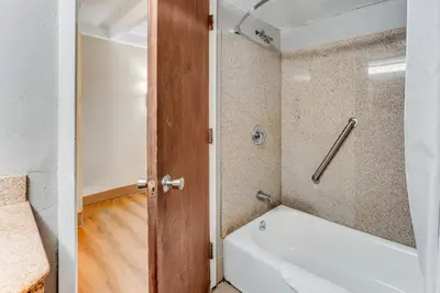 a bathroom with a bath tub and a toilet at Red Carpet Inn & Suites in Philadelphia