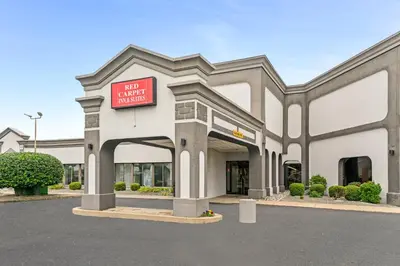 a building with a sign in front of it at Red Carpet Inn & Suites in Philadelphia
