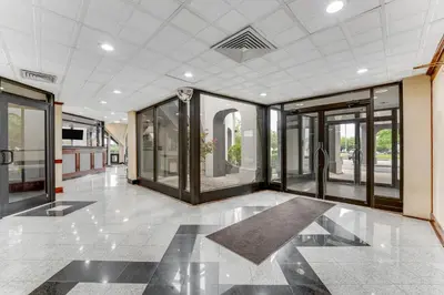 a hallway with glass doors in a building at Red Carpet Inn & Suites in Philadelphia