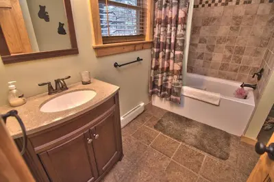 a bathroom with a sink and a shower at Whispering Pines Retreat in Albrightsville