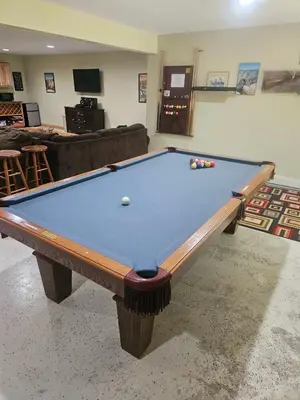 a billiard table in a living room with a couch at Whispering Pines Retreat in Albrightsville