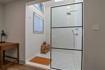 a glass shower in a bathroom with a desk at 3BR, Lakeview, Hot Tub, Nintendo Switch - Deer Haven Poconos Retreat in Tobyhanna