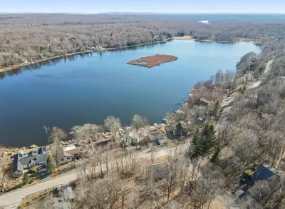 an aerial view of a large lake with houses at 3BR, Lakeview, Hot Tub, Nintendo Switch - Deer Haven Poconos Retreat in Tobyhanna