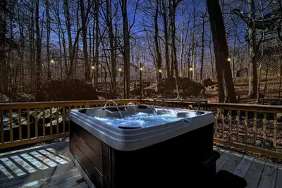 a bath tub sitting on a wooden deck at 3BR, Lakeview, Hot Tub, Nintendo Switch - Deer Haven Poconos Retreat in Tobyhanna