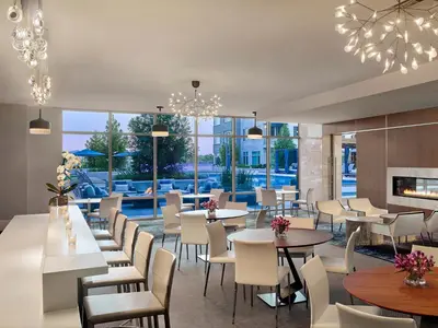 a restaurant with tables and chairs and a fireplace at AVE Florham Park - Furnished Apartment, Florham Park NJ in Florham Park