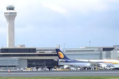 an airplane is parked at an airport with a control tower at CLINTON HILLS - Newark in Newark