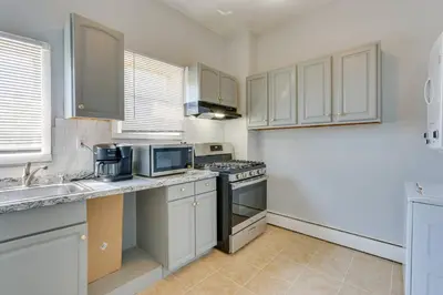 a kitchen with white cabinets and a stove top oven at CLINTON HILLS - Newark in Newark