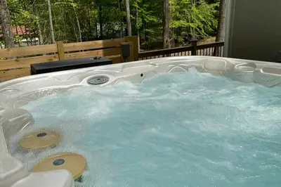 a jacuzzi tub with blue water in it at Casa di Montagna/5BR/3Bath/NearResorts/PetsAllowed in Pocono Lake