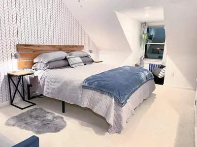 a bedroom with a large bed and a rug at Larry's Lancaster Landing: with fully-fenced yard in Lancaster
