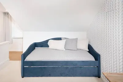 a blue bed with two pillows on it in a room at Larry's Lancaster Landing: with fully-fenced yard in Lancaster