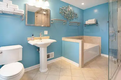 a bathroom with a toilet and a sink and a shower at Larry's Lancaster Landing: with fully-fenced yard in Lancaster