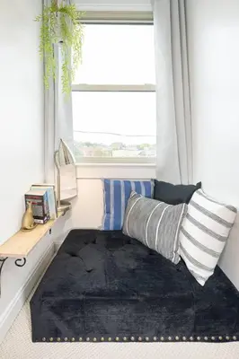 a room with a bed with a black rug and a window at Larry's Lancaster Landing: with fully-fenced yard in Lancaster