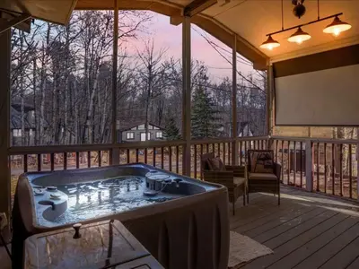 a jacuzzi tub on a screened in porch with a screen at 2BR Cottage with Hot Tub in Tobyhanna