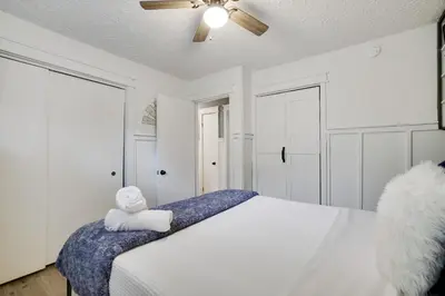 a bedroom with a bed with a teddy bear on it at 2BR Cottage with Hot Tub in Tobyhanna
