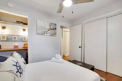 a bedroom with a white bed and a ceiling at 2BR Cottage with Hot Tub in Tobyhanna