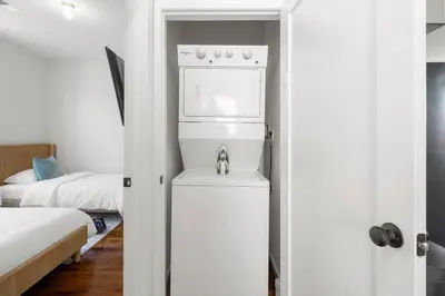 a kitchen with a refrigerator and a stove in a room at Big City Living: Elegant Apartment with NYC Vibes in Jersey City