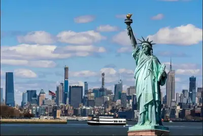 the statue of liberty with a city in the background at Big City Living: Elegant Apartment with NYC Vibes in Jersey City
