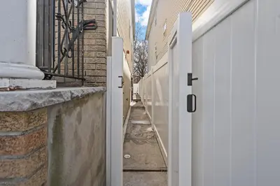 an alley between two buildings with a white door at The Luxurious loft in Newark