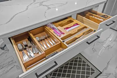 a drawer in a kitchen cabinet filled with utensils at The Luxurious loft in Newark