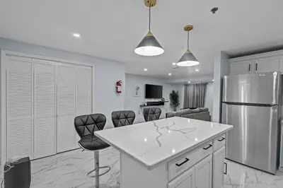 a kitchen with a white counter and a refrigerator at The Luxurious loft in Newark