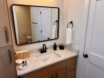 a bathroom with a sink and a mirror at Montgomery Modern Luxury Stays in Montgomery