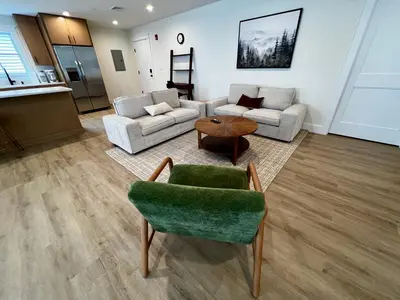 a living room with two couches and a table at Montgomery Modern Luxury Stays in Montgomery