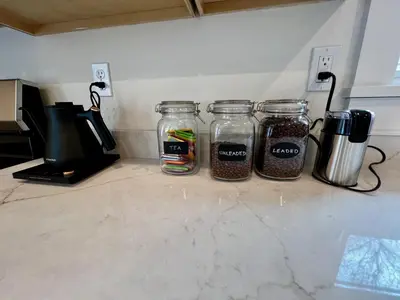 three jars of food sitting on a kitchen counter at Montgomery Modern Luxury Stays in Montgomery