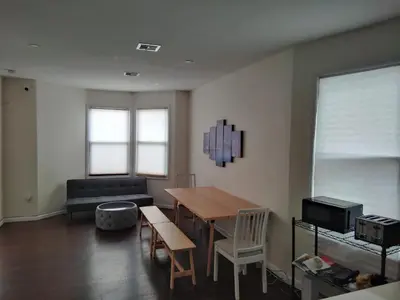 a living room with a table and a couch at NYC HomeBnB in Jersey City