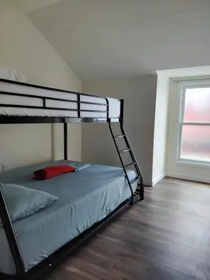 a bunk bed in a room with a window at NYC HomeBnB in Jersey City