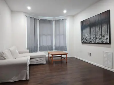a living room with a couch and a table at NYC HomeBnB in Jersey City