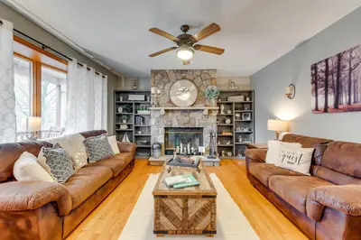 a living room with a couch and a fireplace at Pocono Lake House Hideaway Hot Tub and Theater Room in Pocono Lake