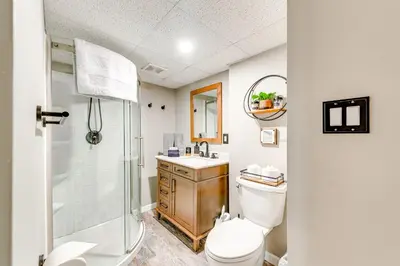 a bathroom with a toilet and a shower and a sink at Pocono Lake House Hideaway Hot Tub and Theater Room in Pocono Lake
