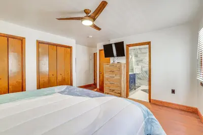 a bedroom with a large bed and a flat screen tv at Spacious Retreat 7 Mi to Tobyhanna State Park! in Tobyhanna