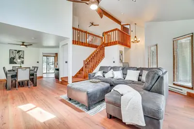 a living room with a couch and a table at Spacious Retreat 7 Mi to Tobyhanna State Park! in Tobyhanna
