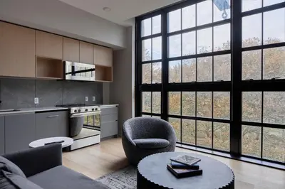 a living room with a couch and a table at Riversuites At The Battery in Philadelphia