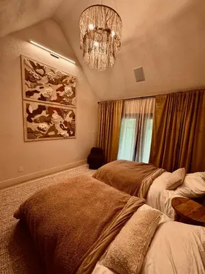 a bedroom with two beds and a chandelier at Stunning Villa in Princeton, NJ in Princeton