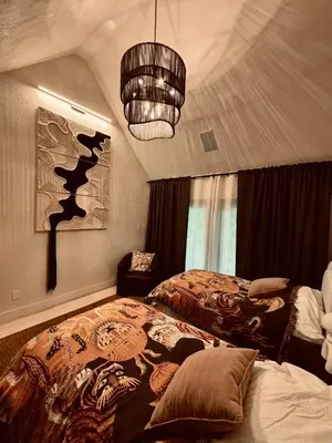 a bedroom with a bed and a chandelier at Stunning Villa in Princeton, NJ in Princeton