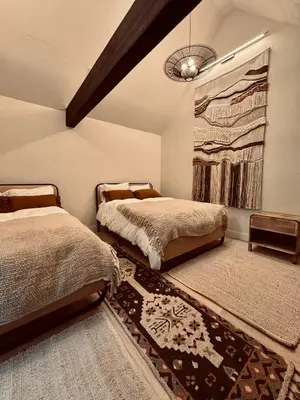 a bedroom with two beds and a rug at Stunning Villa in Princeton, NJ in Princeton