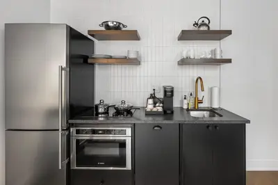 a kitchen with a stainless steel refrigerator and a sink at Sosuite at The Loxley - Old City in Philadelphia