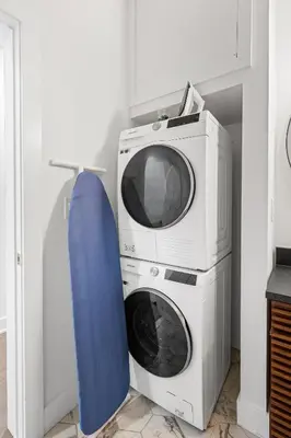 a microwave and a washing machine with a blue surfboard at Sosuite at The Loxley - Old City in Philadelphia