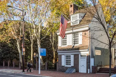 a house with an american flag in front of it at Sosuite at The Loxley - Old City in Philadelphia