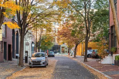 a small car parked on a street with trees at Sosuite at The Loxley - Old City in Philadelphia