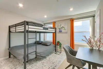 a bedroom with a bunk bed and a desk at Modern City Getaway Near Downtown Newark & NYC in Newark