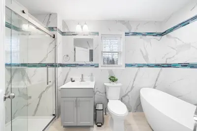 a bathroom with a toilet and a sink and a shower at Big Villa,4 Masters, Heated Pool, Hot Tub, Sauna in Blakeslee