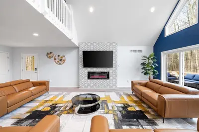 a living room with two brown couches and a tv at Big Villa,4 Masters, Heated Pool, Hot Tub, Sauna in Blakeslee