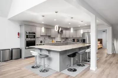 a kitchen with a large island with bar stools at Big Villa,4 Masters, Heated Pool, Hot Tub, Sauna in Blakeslee