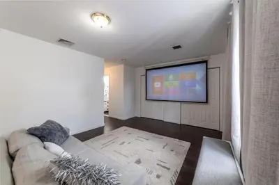 a living room with a couch and a flat screen tv at Huge 3BR Urban Gem just 3 miles to NYC plus Free Parking in Jersey City