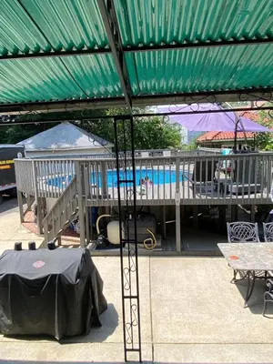 a patio with a green roof and a swimming pool at Elizabeth New Jersey bedroom -Newark Airport -New York City in Elizabeth